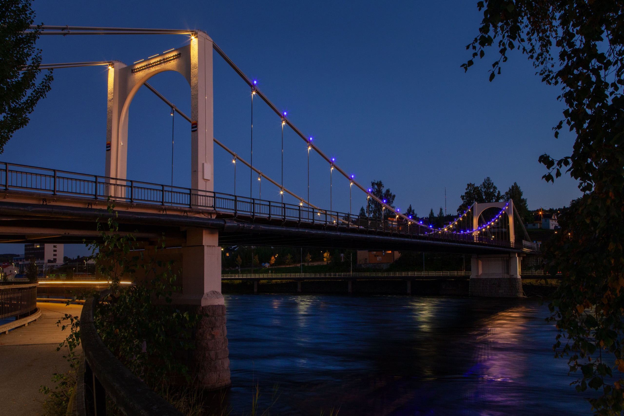 a view of the kongsvinger bridge during blue hour with the new lighting on the pillars and color changing dots on the main cable structure